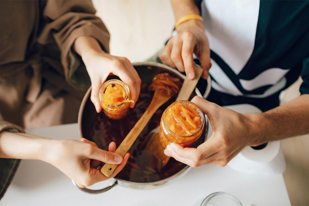 two people canning jam