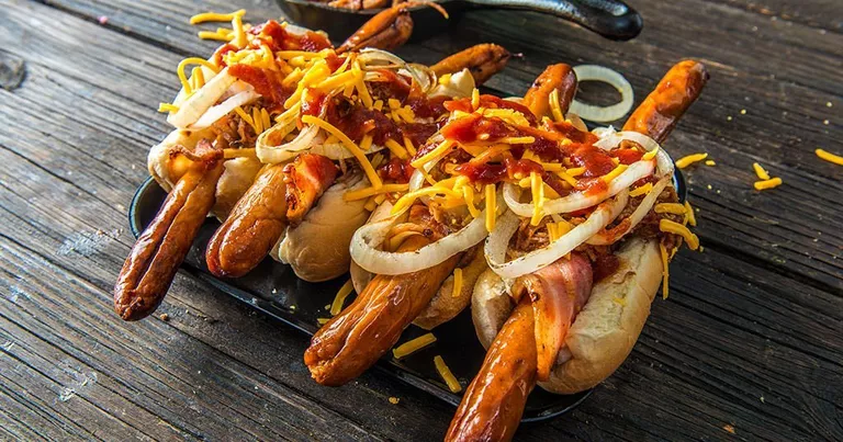 bacon-wrapped hot dogs on a grill